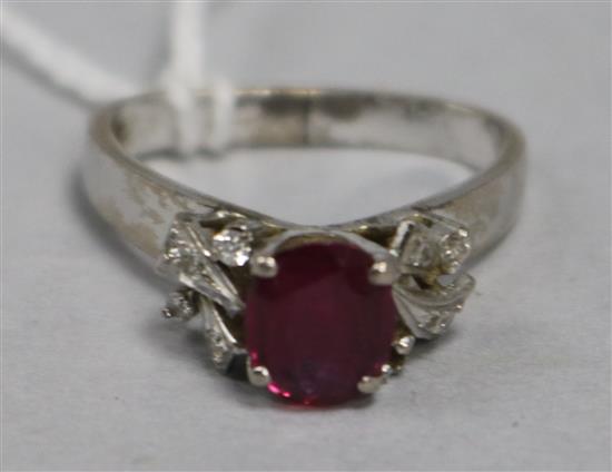 A ruby and diamond ring in white metal setting and triangular shaped shank, size H/I